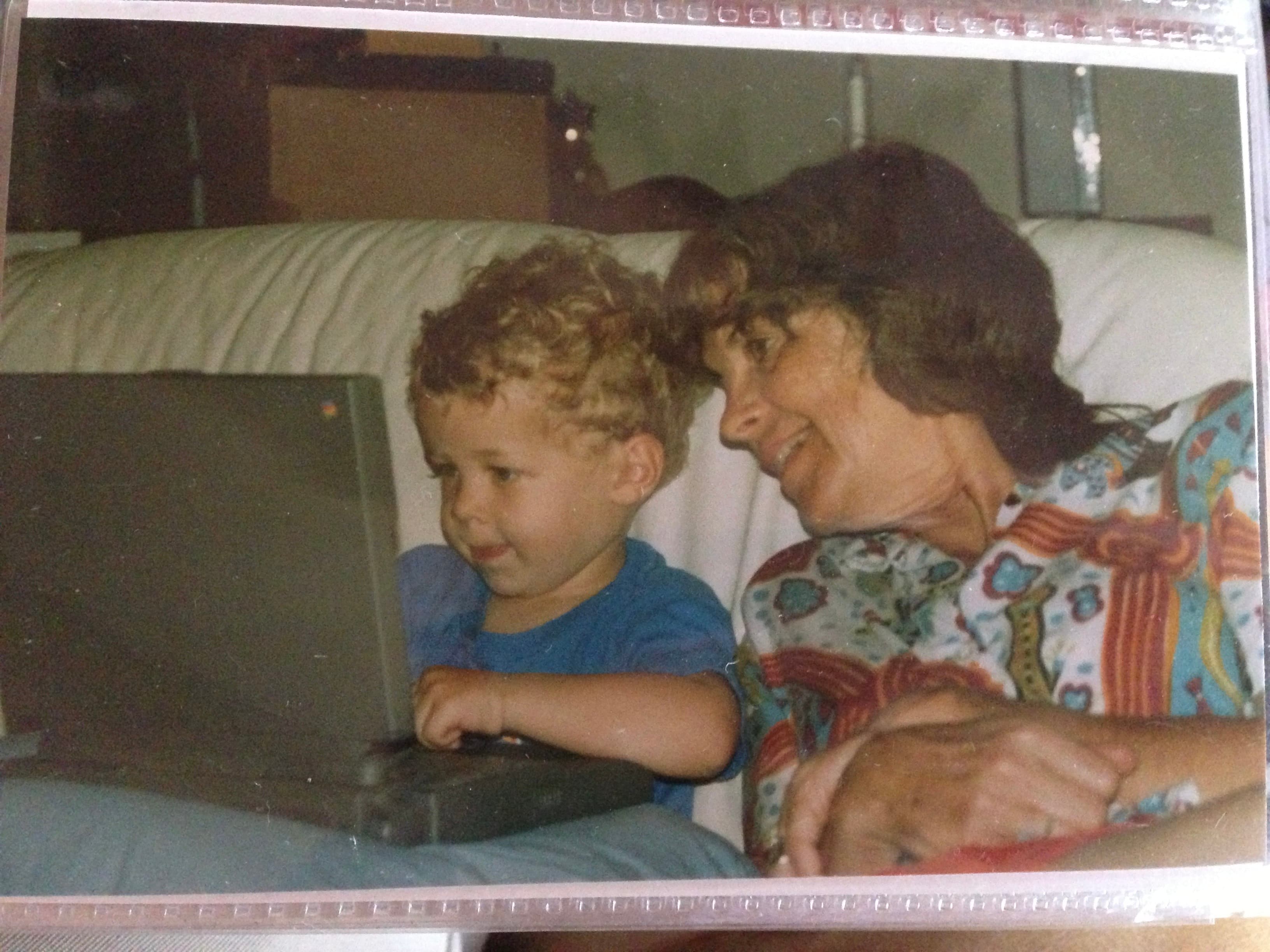 Me sitting at a computer at age 2 with my grandmother